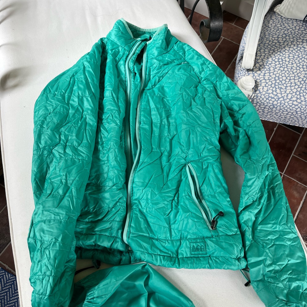 Rei brand packable jacket.  Wind proof and waterproof.  Runs small